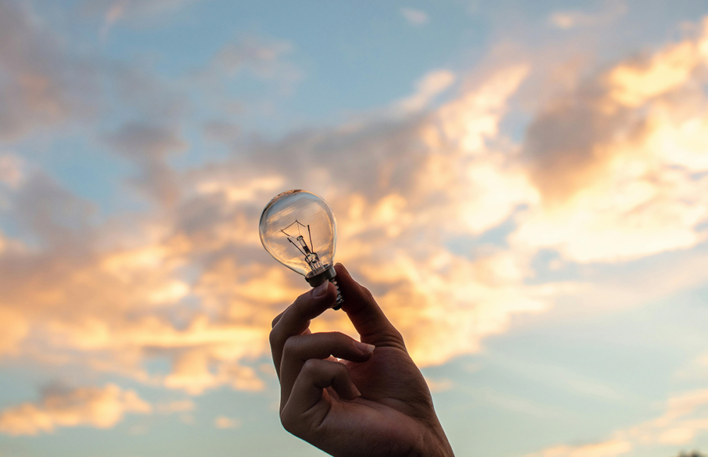 Handing holding a lightbulb