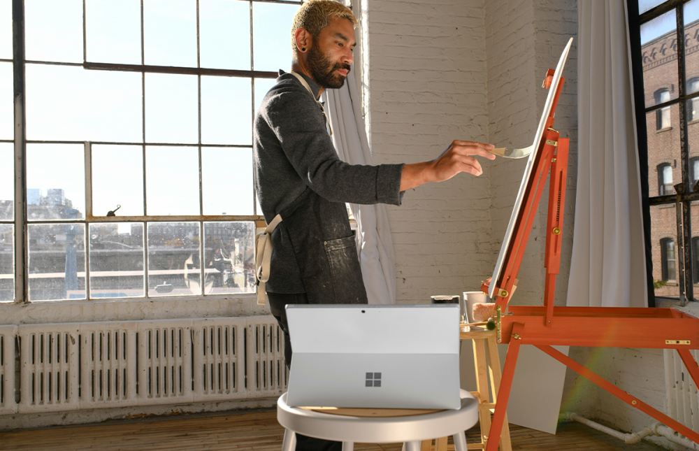 Guy in a suit painting 