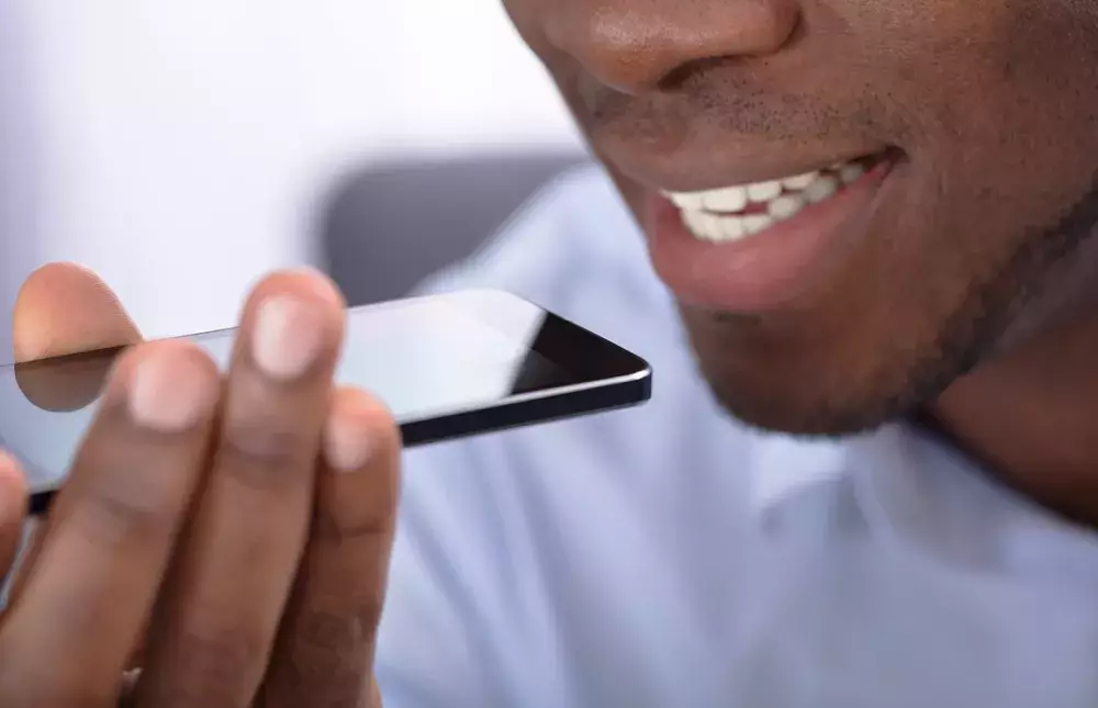 guy speaking into the microphone of a cellphone