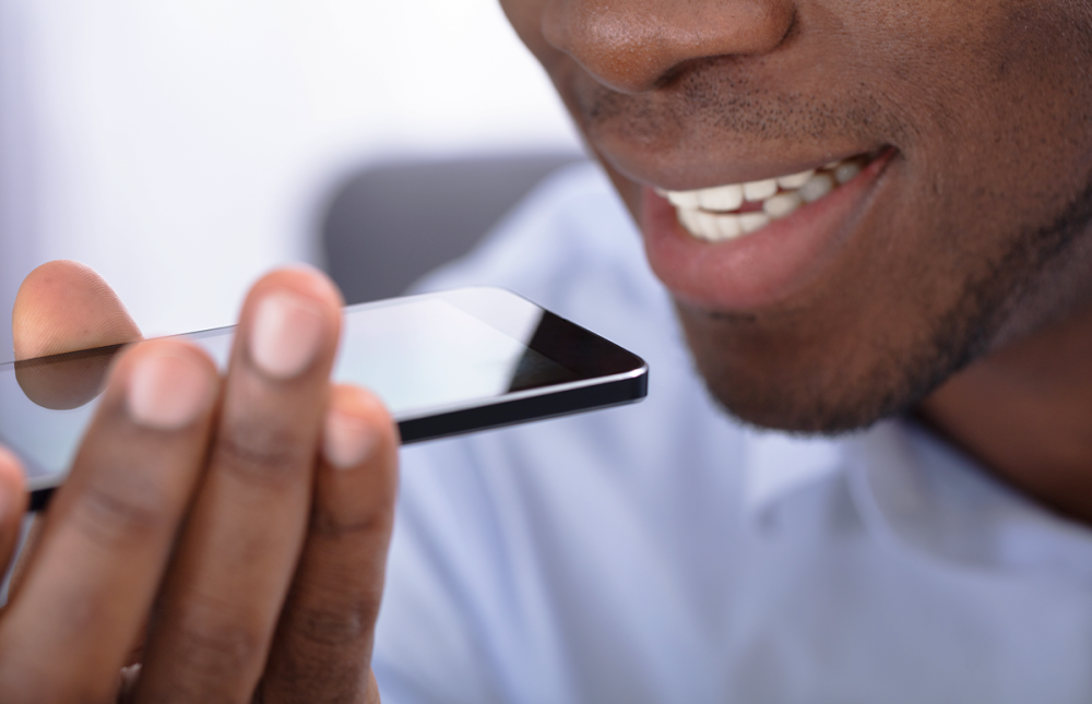 guy speaking into the microphone of a cellphone