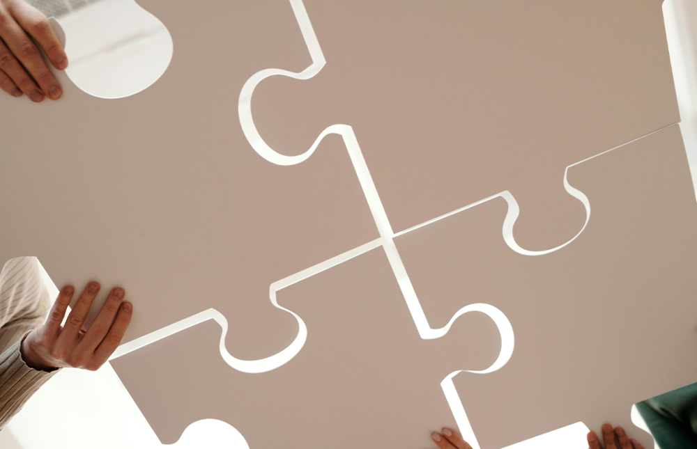 people connecting giant puzzle pieces