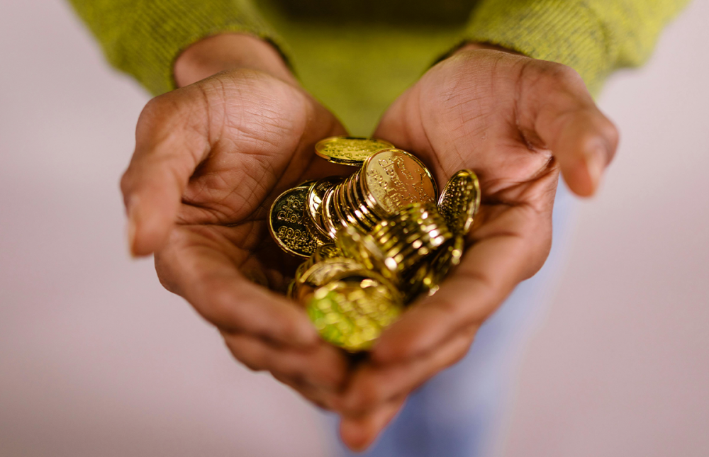Hands holding coins
