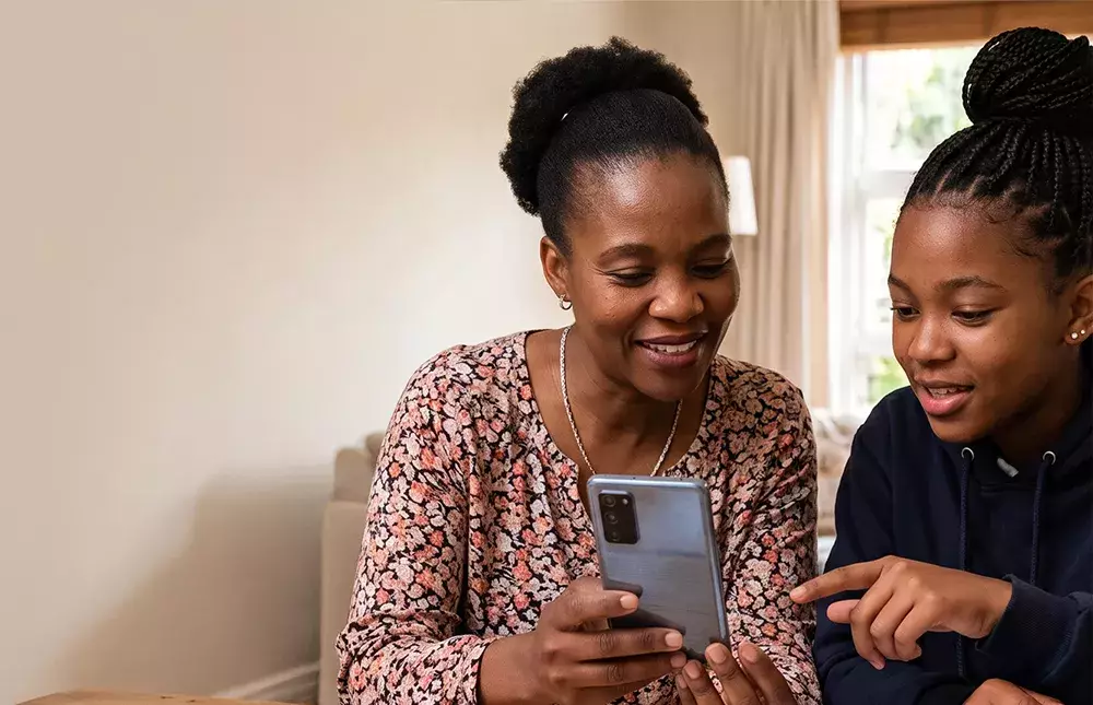 Women showing daughter information on the phone